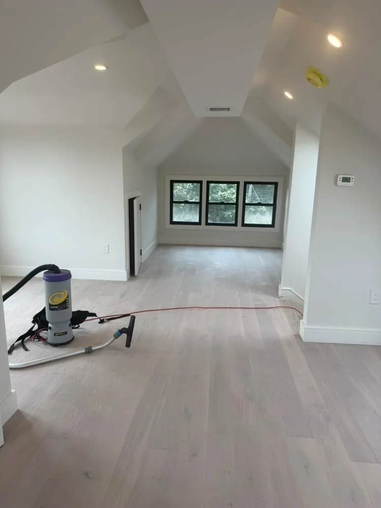 Finished attic room with a vaulted ceiling and new light wood flooring