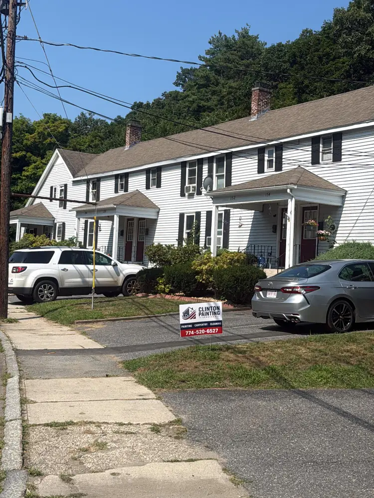 Clinton Painting Services yard sign on the lawn of a home under way