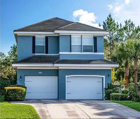 Two story house with fresh blue siding, white trim and a tidy front yard