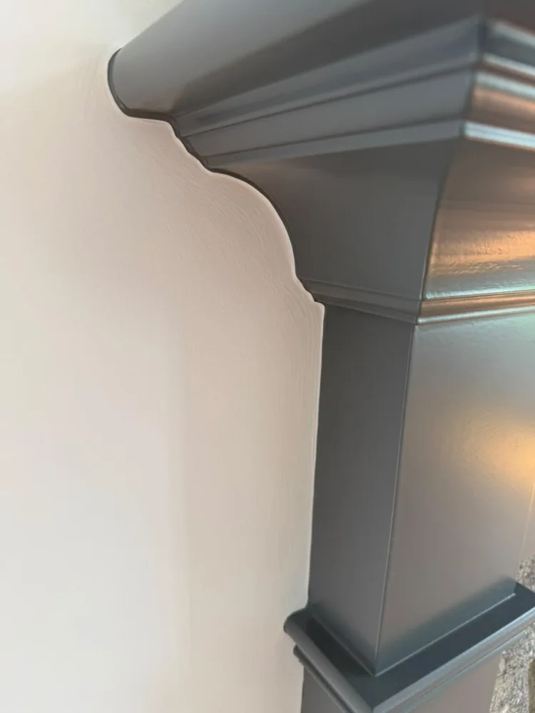Gray painted mantel corner with a crisp corbel profile