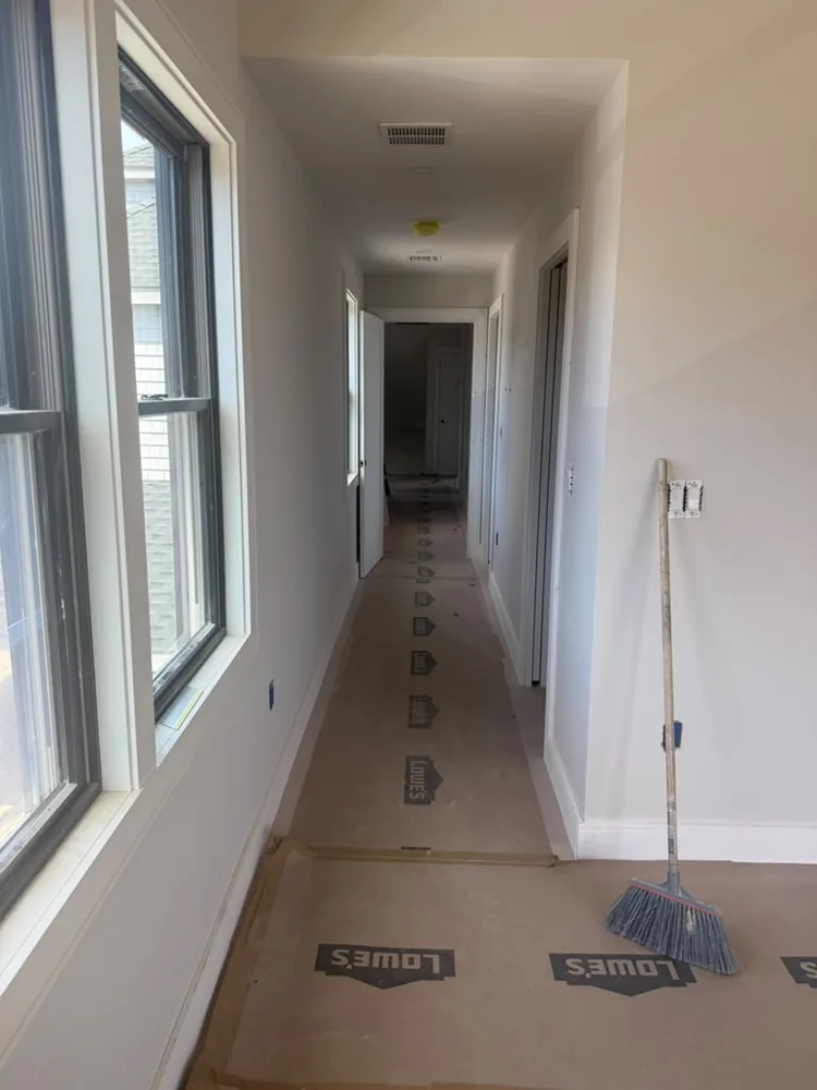 Freshly painted hallway with the new floor under protective paper