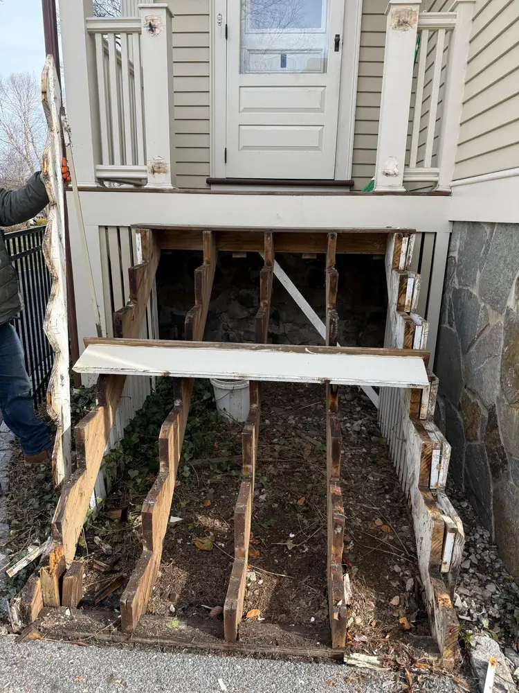New posts set under a front porch while the stairs are rebuilt