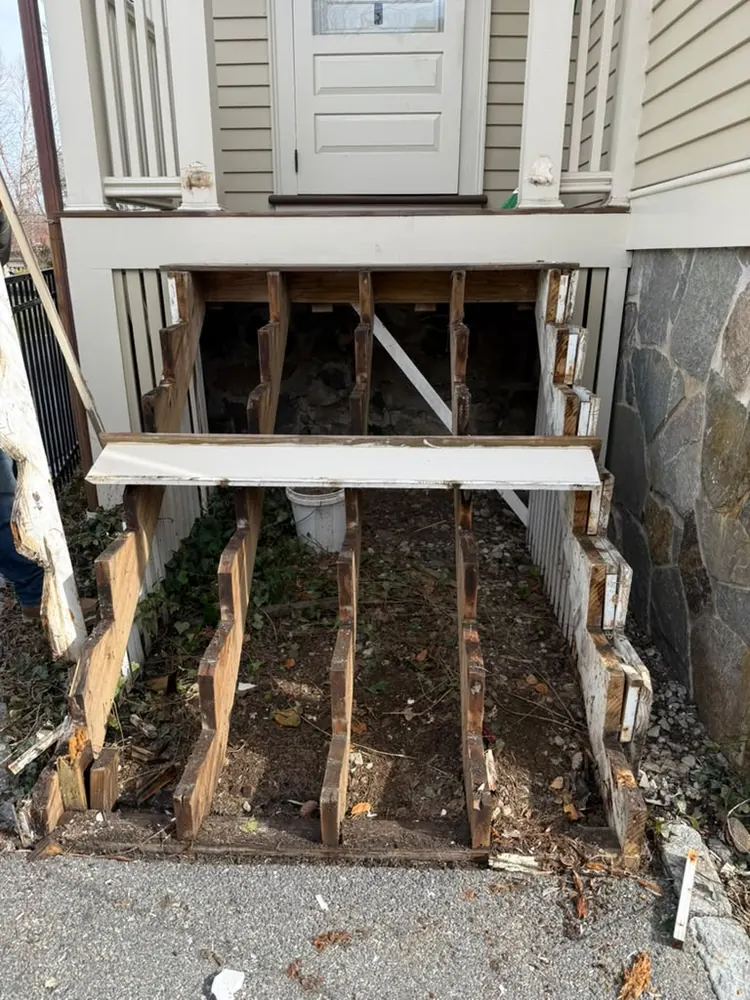 Porch stairs stripped to the stringers before the rebuild