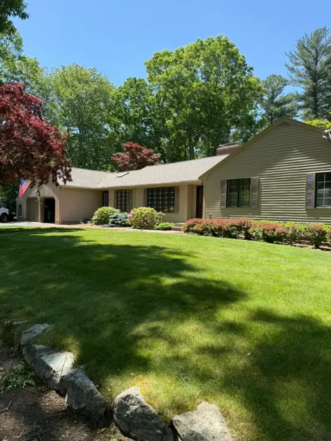 Ranch house with a manicured lawn after new exterior paint