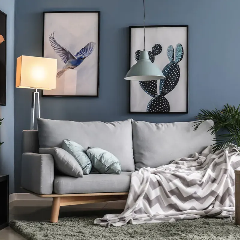 Gray sofa against a dusty blue painted wall in a Framingham MA living room