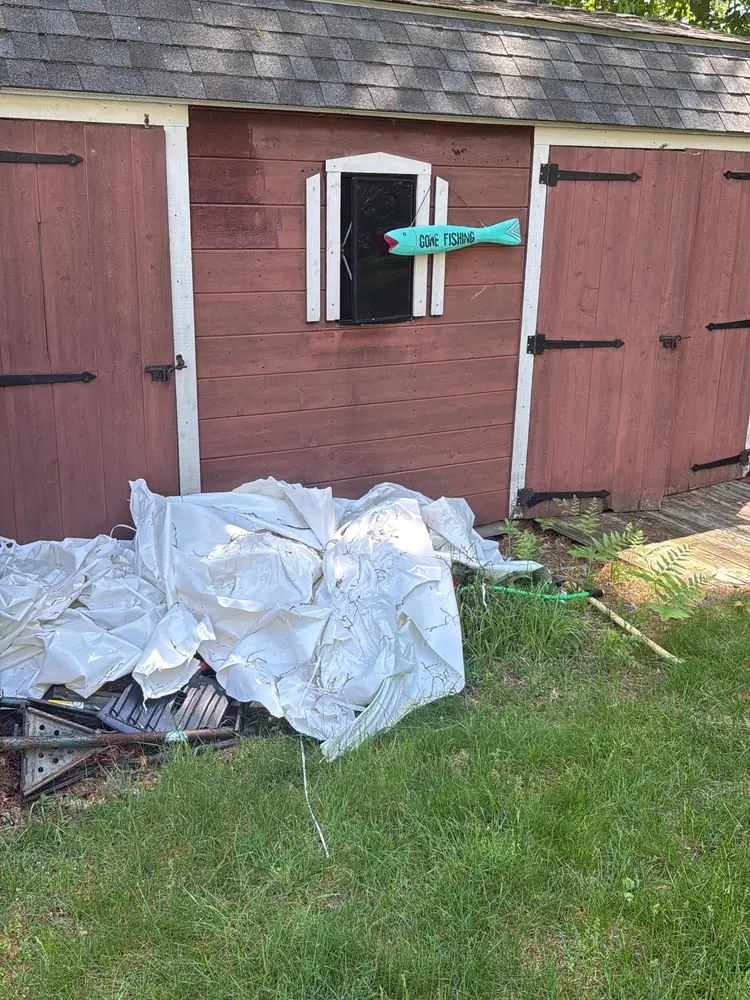 Backyard shed before painting, with faded red siding and worn trim